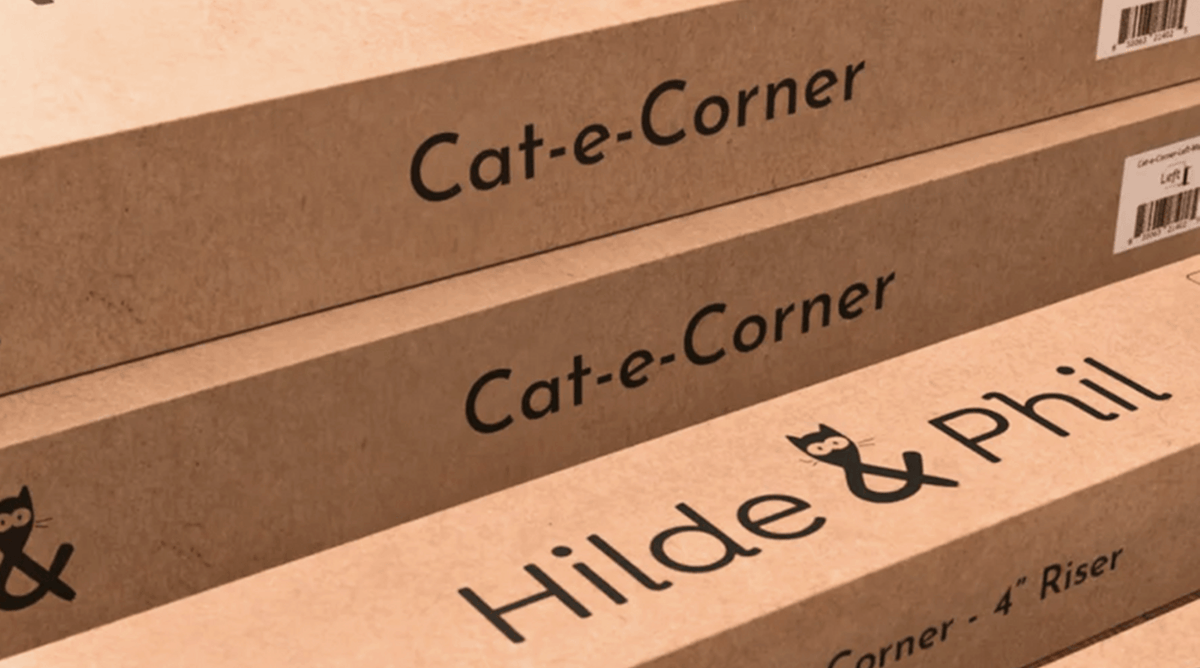 Stacked cardboard boxes display Cat-e-Corner and Hilde & Phil branding